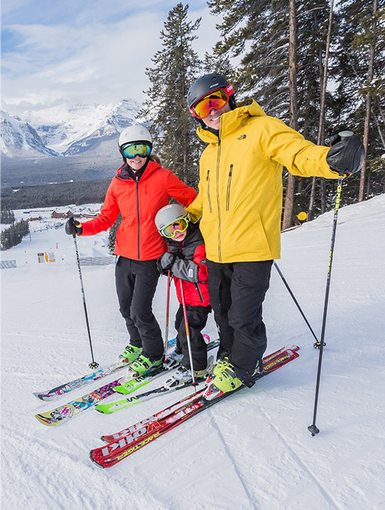 Mom, dad, and little boy skiing at Lake Louise Ski Resort.
